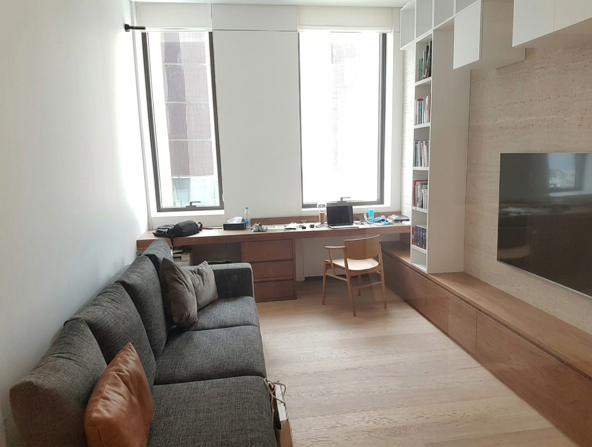 3 Beirut Residence: TV room with oak joinery and a built-in desk